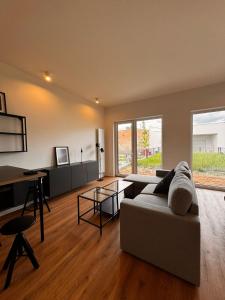 a living room with a couch and a table at Apartmán v komplexu Meridiem in Komárov