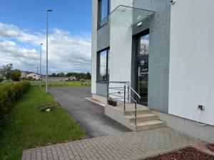 a building with a glass door and stairs on it at Mangal Hotel in Olgina