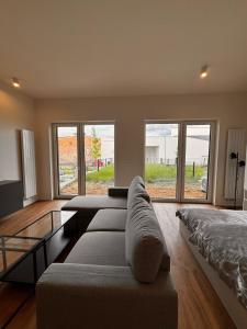 a living room with a couch and a bed at Apartmán v komplexu Meridiem in Komárov
