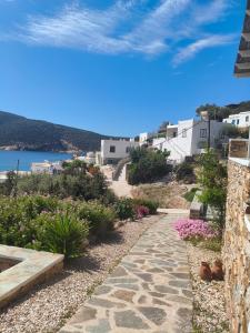a walkway leading down to a beach with buildings at Thimari villas in Vathi