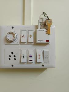 a white remote control with a padlock on it at Swami Inn Lodging in Trimbak