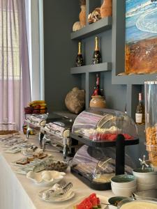 a table with many different types of food on it at Hotel LEODORI 3 suites in Shëngjin