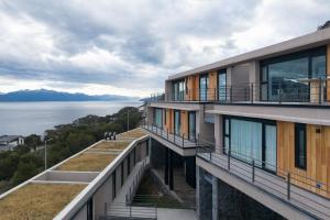 an apartment building with balconies overlooking the water at Costa Susana Ushuaia in Ushuaia