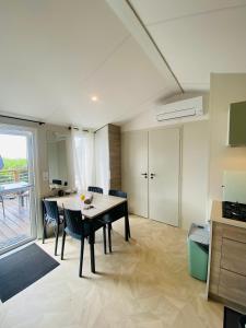 a dining room with a table and chairs in a room at Premium Sea View in Saint-Raphaël