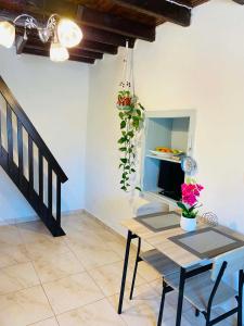 a table and chairs in a room with a table and flowers at Plativola Mountain View in Sitia
