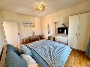 a bedroom with a bed and a tv in it at ThePAGHouse in Pag