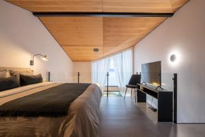 a bedroom with a large bed and a flat screen tv at Costa Susana Ushuaia in Ushuaia