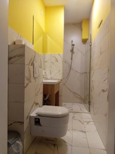 a bathroom with a white toilet and a shower at Apartmani Masline Međugorje in Međugorje +42 photos