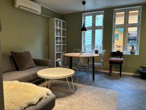 a living room with a couch and a table at Bergen City hostel Rooms in Bergen