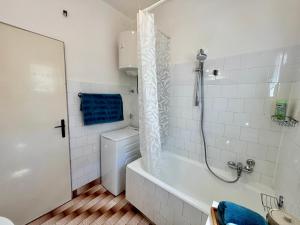 a bathroom with a tub and a toilet and a shower at ThePAGHouse in Pag +66 photos
