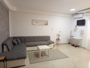 a living room with a couch and a table at Apartmani Masline Međugorje in Međugorje