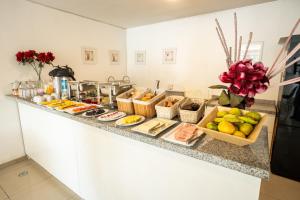 a kitchen counter with a bunch of food on it at Hoteles Riviera Ejecutivo in Arequipa