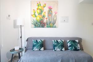 a couch in a room with a painting on the wall at Row 7 Holiday Homes in Kyrenia