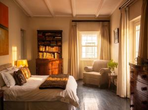 a bedroom with a bed and a chair and a window at Hawksmoor House in Stellenbosch +119 photos