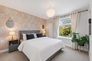 a bedroom with a large bed and a window at Panoramic Sunset Views - Free Parking & Sleeps 5 in Heywood
