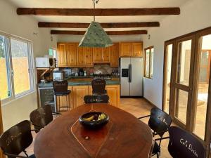a kitchen with a large wooden table and chairs at Large studio with private patio in Casa Cornucopia in San José del Cabo