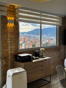 a view of a city from a window in a room at 2201 Hermoso apartamento poblado in Medellín