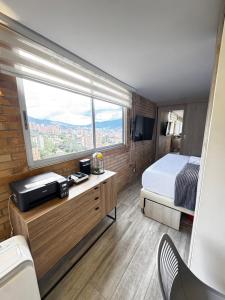 a bedroom with a bed and a large window at 2201 Hermoso apartamento poblado in Medellín