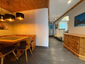 a dining room with a table and chairs at Viktoria B19 by Arosa Holiday in Arosa