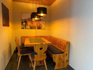 a dining room with a wooden table and chairs at Viktoria B19 by Arosa Holiday in Arosa