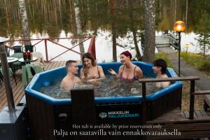 a group of people in a hot tub at Kyyronkaita in Mikkeli