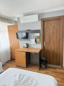 a bedroom with a desk and a bed and a door at Hotel Otağ in Istanbul