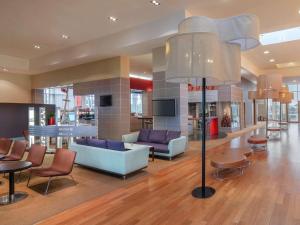 a lobby with couches and chairs in a building at Novotel London Excel in London