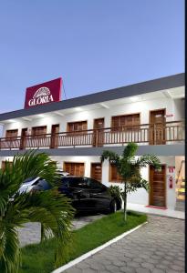 a black car parked in front of a hotel at Hotel Glória in Piranhas