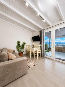 a living room with a couch and a table at Deon in Vlorë