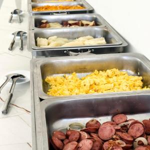 three trays of food with sausage and other foods at Hotel Glória in Piranhas +19 photos