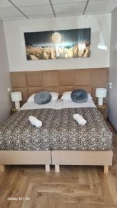 a bedroom with a bed with two pillows on it at Wrzosowa 34 in Augustów