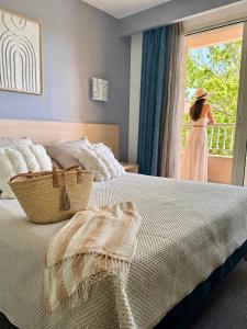 a woman is looking out the window of a bedroom at Hôtel Restaurant L' Empereur in Aléria