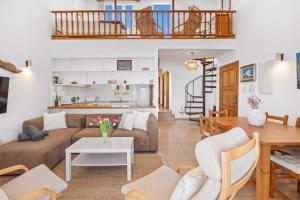 a living room with a couch and a table at Tramontana 113 P1 by 3VILLAS in Fornells