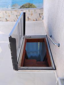 a stairwell in a building with a window at Triplex com linda vista para o mar de Parati Anchieta ES in Anchieta