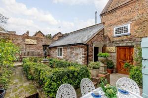 an old brick house with a garden and chairs at 3 Bed in Ludlow oc-82889 in Ludlow