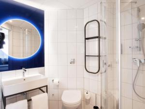 a bathroom with a toilet and a sink and a shower at Ibis Warszawa Stare Miasto in Warsaw