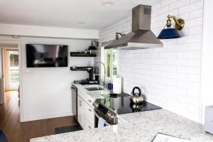 a kitchen with a sink and a stove top oven at Endless Summer Oceanside Views in Boston