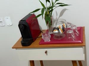 a toaster sitting on top of a table with a plant at Apartamento 2 quarto e garagem G para 2 carro in Rio Verde