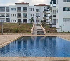 a large swimming pool in front of a building at Cité Marine in Mansouria