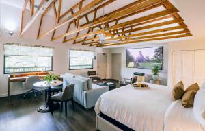 a bedroom with a large bed and a desk and a room with a desk at All-Movie Hotel in Peachtree City