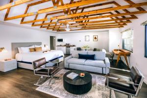 a bedroom with a bed and a living room at All-Movie Hotel in Peachtree City