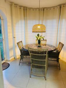 a dining room table with chairs and a pendant light at Ca Isaak in Denia