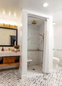 a bathroom with a sink and a toilet and a mirror at All-Movie Hotel in Peachtree City