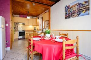 a kitchen with a table with a red table cloth at Gîte Le Nain Rouge in Kaysersberg