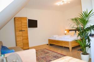 a bedroom with a bed and a tv on the wall at Weingut Primus Südsteiermark in Spielfeld