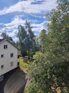 an aerial view of a white house and trees at Apartment with some lake view in Sävsjöström