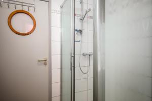 a shower in a bathroom with a mirror at Gîte Le Nain Rouge in Kaysersberg +24 photos