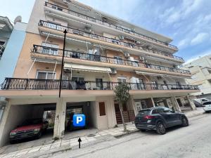 a large building with cars parked in front of it at My Home in Alexandroupoli