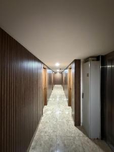 a long hallway with wooden walls and a hallway with a corridorngthngthngthngth at Hotel Otağ in Istanbul