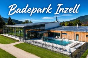 a large building with a swimming pool and the words backyard interval at Hardi's Hotel in Inzell